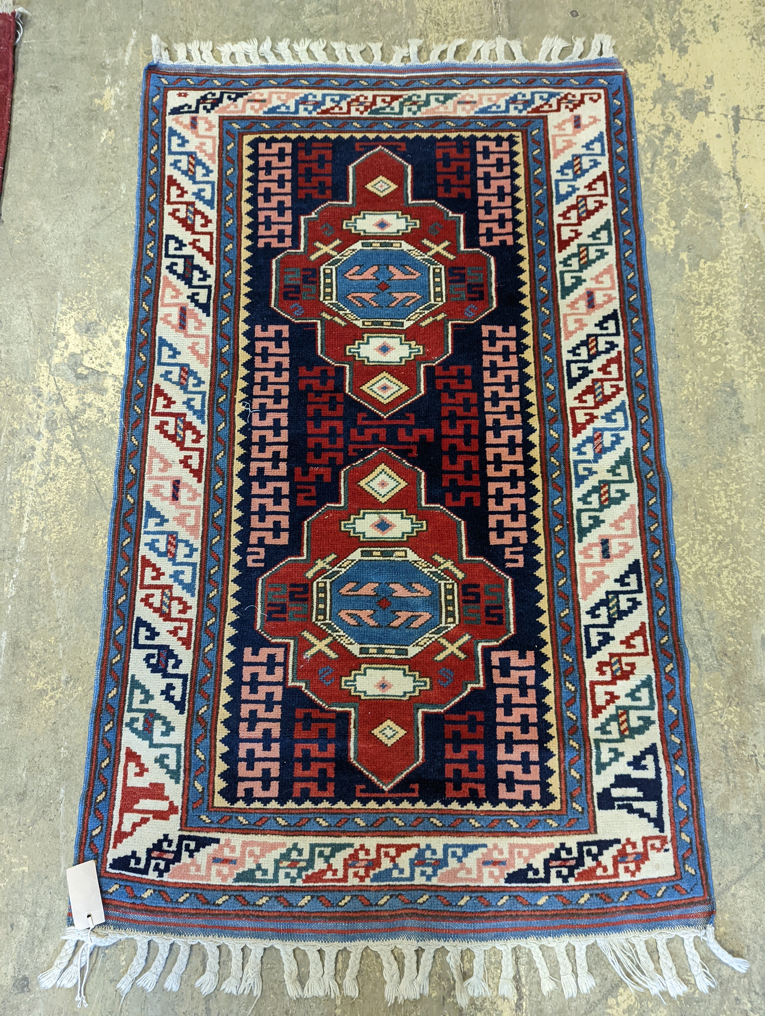 A Caucasian blue ground rug, 126 x 77cm